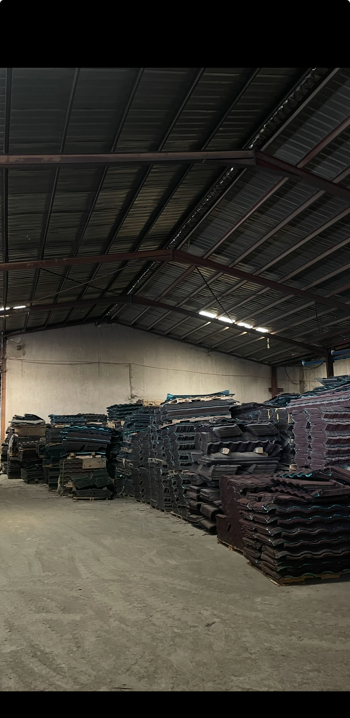 MORE FINISHED STONE COATED ROOF TILES READY FOR USE IN THE STORAGE UNIT